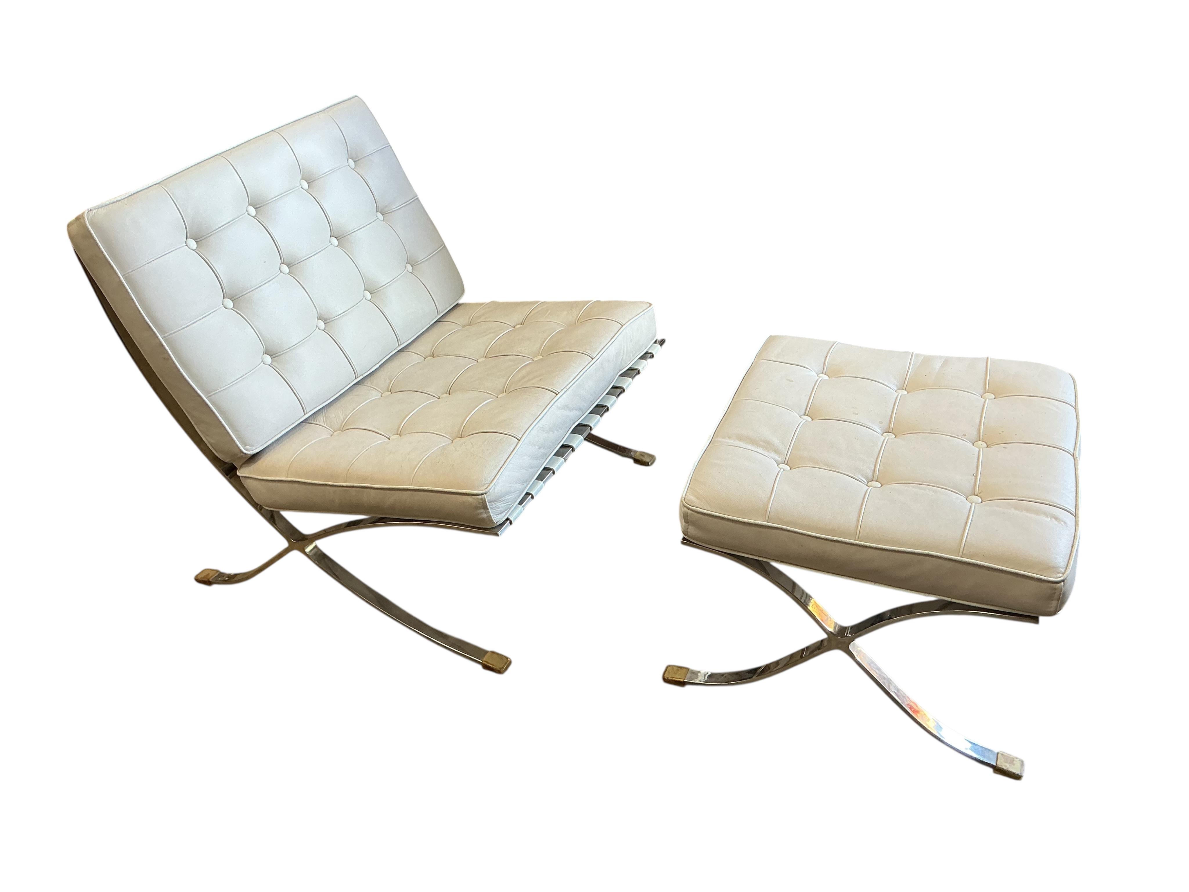 A pair of 'Barcelona' style white leather chairs, width 78cm, depth 80cm, height 82cm and a footstool